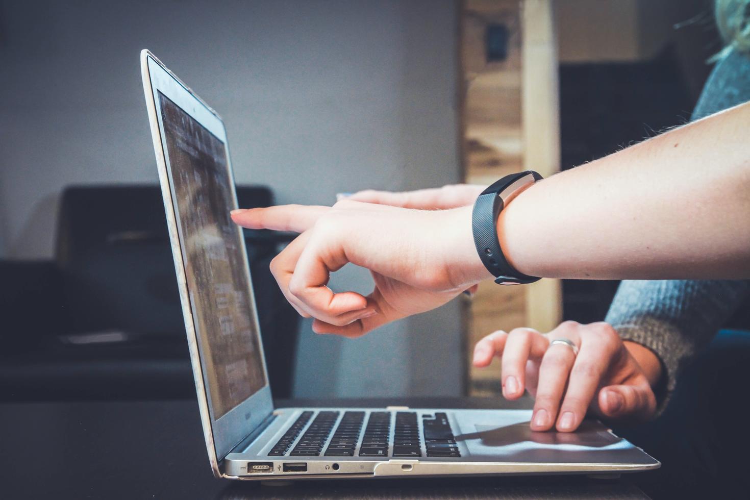Hands pointing on a laptop screen